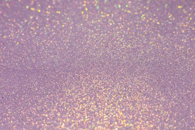 Soyut parıltı ışıkları desenli menekşe ya da mor ve altın arkaplan, odaklanmamış, bokeh. Noel ya da Yeni Yıl Festivali ışıl ışıl arka plan, kış tatili kartı kavramı