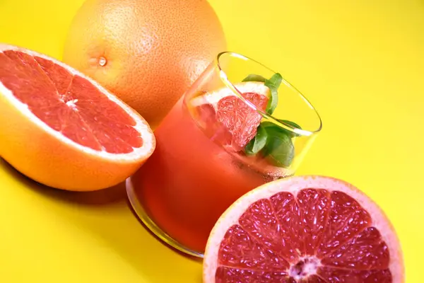 stock image Fresh grapefruit in a glass glass with fresh fruit