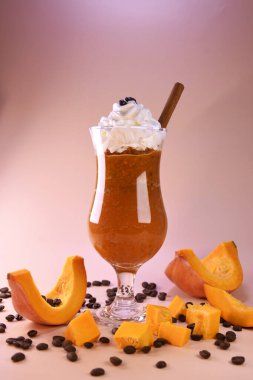 glass of orange smoothie with cinnamon. pumpkin laste with whipped cream. hot spicy drink for warm autumn evenings. healthy nutritious drink. clipart