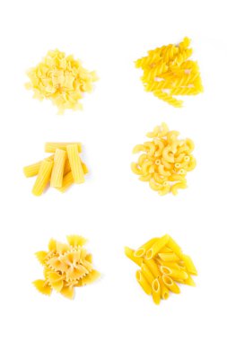 Beyaz arka plana serilmiş altı çeşit çiğ İtalyan makarnası. Farklı şekillerde makarna: fusilli, penne, farfalle, rigatoni, kabuklu makarna ve erişte..