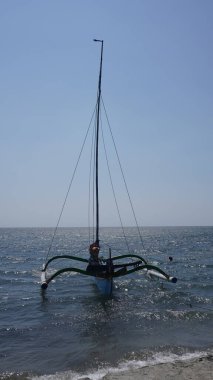 Gün boyunca Pasir Putih Situbondo sahilinde geleneksel bir tekne.