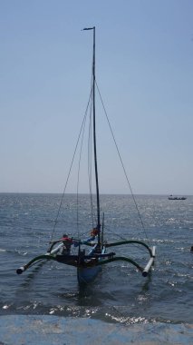 Gün boyunca Pasir Putih Situbondo sahilinde geleneksel bir tekne.