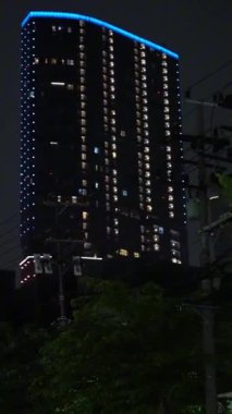Geceleri Surabaya şehrinde ışıkları olan bir otel ya da apartman.