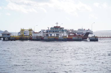 The ship dock in Ketapang, Banyuwangi in the morning clipart