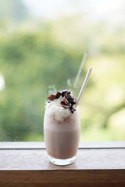 stock image Cold chocolate milkshake drink with foam and cereal topping