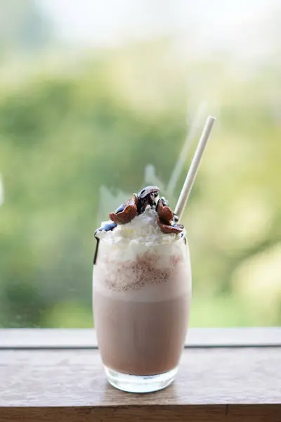 stock image Cold chocolate milkshake drink with foam and cereal topping