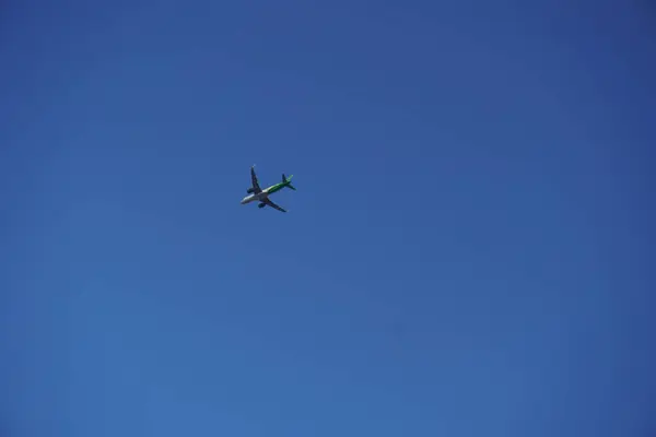 stock image A plane just took off from an airport with a blue sky in the afternoon