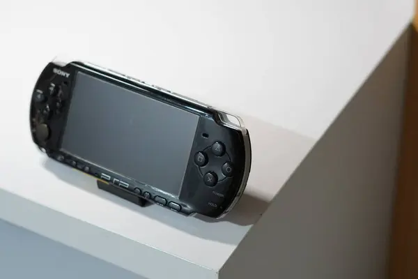 stock image A black handheld game console from Sony called PSP on a white table