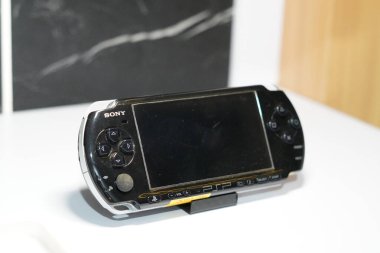 Sony 'den gelen PSP adlı siyah el bilgisayarı oyun konsolu beyaz bir masa üzerinde