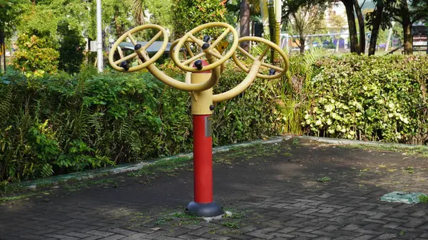 stock image Public sports equipment in the Singha park in Malang that can be used by the community to train their hand muscles by turning the wheels