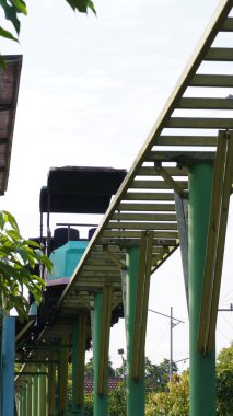 Uzun zamandır çalışmayan ve durdurulan Taman Singha Malang 'da bisiklet sürüşleri. Tren ve raylar da paslı görünüyor.