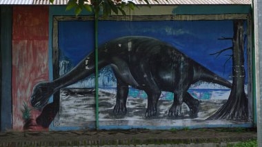 The sidewalk at Singha Park Malang in the morning with various kinds of murals on the walls clipart