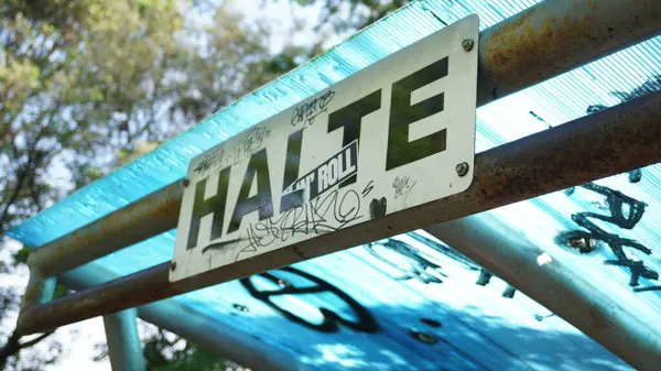 stock image Halte inscription in Indonesian on a garden that has been scribbled on