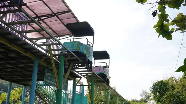 stock image Sky bike rides in Taman Singha Malang which have not been operating for a long time and are stalled. The train and rails also look rusty