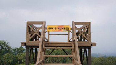 The bridge on the Bukit Kuneer which is made of wood and a photo spot for visitors at Wonosari Malang tea garden clipart