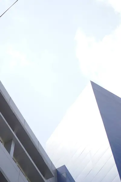 stock image Blue building exposed to sunlight during the day with a clear sky