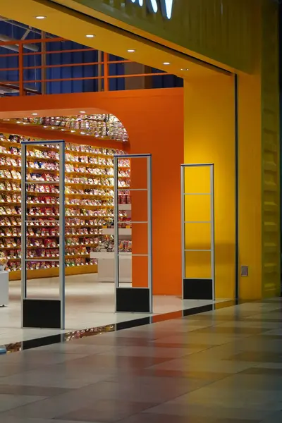 stock image The entrance to a yellow shop with no people passing by inside a mall