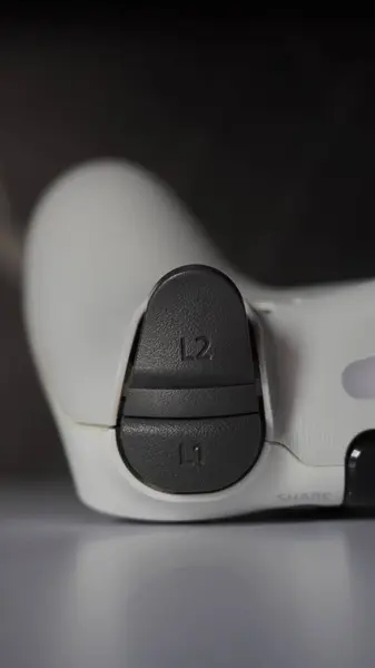 stock image The L1 and L2 buttons on the white Playstation 4 controller