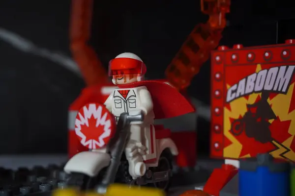 stock image The lego duke caboom minifigure which is a character from the movie Toy Story 4 is riding his motorbike to get ready