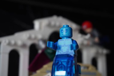 Hydro man minifigure standing on his water throne with a bridge in the background clipart