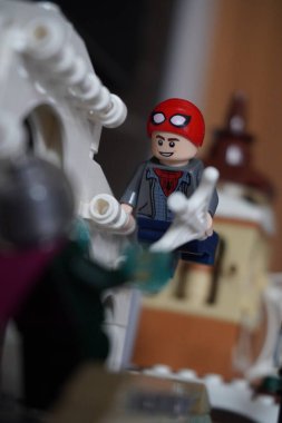Yarı açık maskeli Peter Parker (Örümcek Adam) köprüde Mysterio ile dövüşüyor.