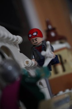 Yarı açık maskeli Peter Parker (Örümcek Adam) köprüde Mysterio ile dövüşüyor.