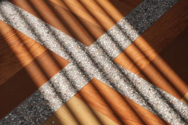 stock image Shadows of oblique lines that hit the surface of the brown tiles with white lines in the afternoon