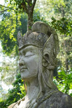 Kemesraan Park, Pujon, Batu Malang 'daki yeşil ağaçların arka planına sahip bir Endonezya hikayesinden dev bir tanrı veya tanrıça heykeli.