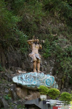 God statue in Kemesraan Park, Pujon, Batu, Malang with a background of cliffs and plants clipart