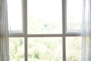 Minimalist white box-shaped window with curtains open during the day clipart