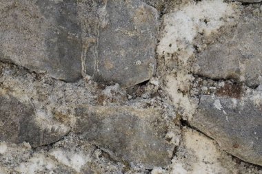 Yığılmış gri kireç taşından yapılmış bir duvardaki soyut arkaplan