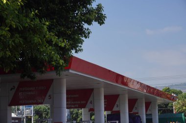 The Pertamina gas station with the type of gasoline they sell on the side of the main road that leads to the city of Situbondo clipart