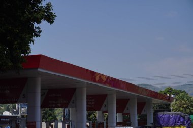 The Pertamina gas station with the type of gasoline they sell on the side of the main road that leads to the city of Situbondo clipart