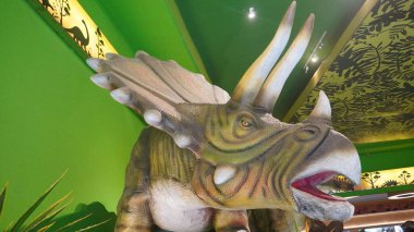 Dino Park Jatim Park 3 'ün girişinde ağzı açık Triceratops heykeli.