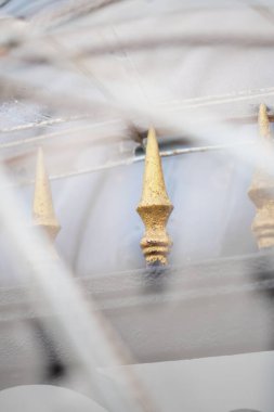 The sharp part of a house fence seen from between the holes in the fabric clipart