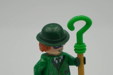 Lego minifigure The Riddler from DC Superheroes movie with question mark stick and white background clipart