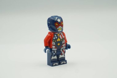 Lego mini figure Justin Hammer bricks toy with red and blue costume on white background clipart