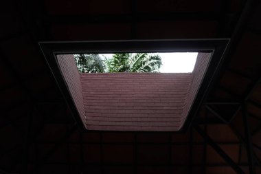 The roof of a building that is open in the middle to let in light clipart