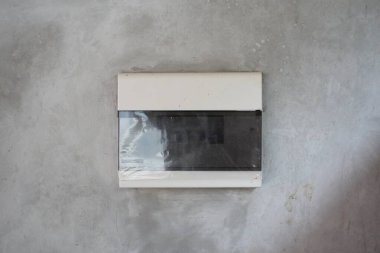 Electrical switch box in a cement wall clipart