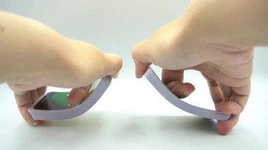 UNO Flex 'in beyaz arka planla el ele oynadığı kartları karıştırmakta başarısız olan bir el