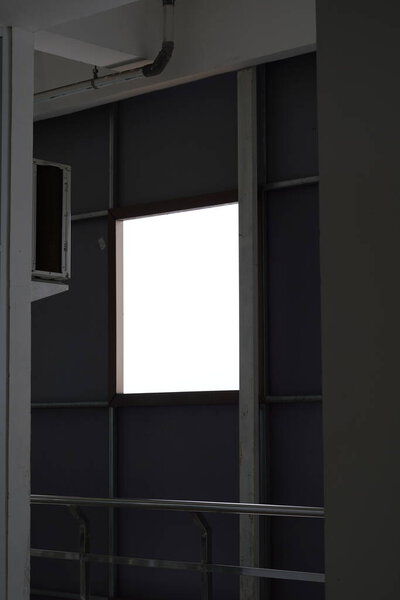 A box hole in a minimalist multi-storey building near the outdoor air conditioner