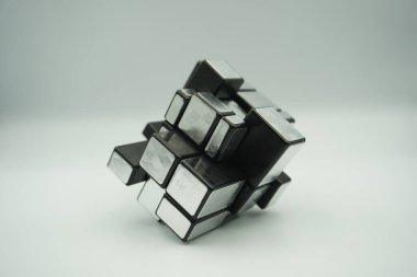 A 3x3 silver rubik's mirror cube toy that is scrambled on a white background clipart