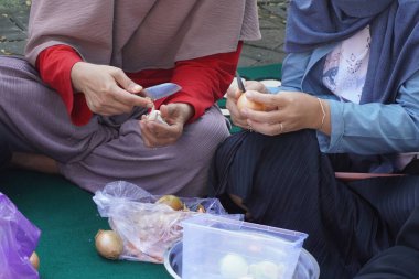 Gün boyunca soğan soyan iki kadının elleri.
