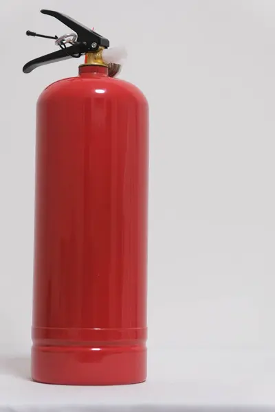 red fire extinguisher on a white background fire safety
