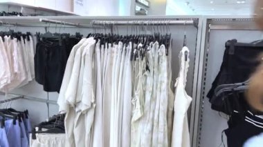 Vietnam 'da bir mağaza, Avrupalı bir kız kasada kıyafet seçiyor, Asyalı ve çok uluslu kadınlar, erkekler kıyafet alıyor, kasiyer makbuz veriyor, Vietnam Ho Chi Minh City 05.11.2024