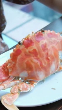 Bir restoranda yengeci özel bir aletle kesen kadın elleri. Büyük yengeç lezzetli pişirme. Masanın üzerinde kaynatılmış lüks bir otel büfesi. Yüksek kalite