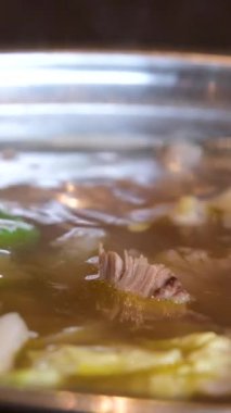 Yakın plan kızartma tavasında et suyu pilavı pilav vermicelli ve sebzeli kız Vietnam 'ı pişirmek için açık büfede yemeğini karıştırıyor. Vietnam çorbası pişir..