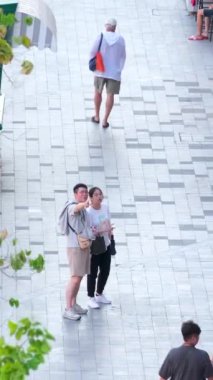Renkli evlerle dolu güzel bir şehirde yürüyen yayalar hafta sonları yürüyen aileler Grand World, Vietnam Phu Quoc 06.16.2024 'ü görüyorlar.