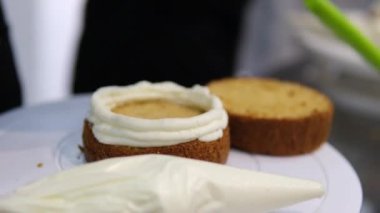 Bento keklerinin kremasını palet bıçağıyla düzleştiriyorum. Yakın plan. Web siteleri için tatlı, yemek fotoğrafı. Seçici odaklanma. Master sınıfı aşçılık okulunun tatlıları