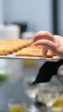 Freshly Baked Eclairs Lined Up in Display at a Pastry Shop. Close-up view of fresh, golden eclairs filled with creamy custard, showcased in a pastry shop. Perfect for dessert enthusiasts. 